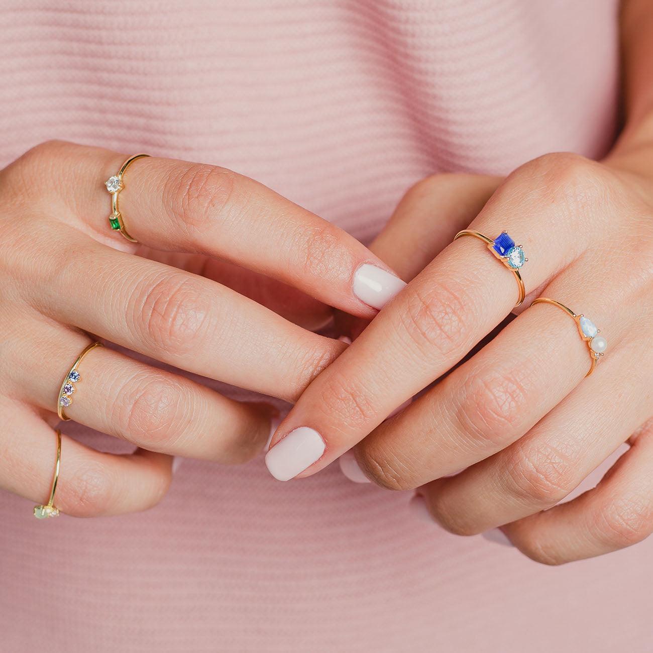 Hands with Coretta Silver ring and other rings with zirconia by Adamina