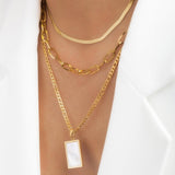 Photo detail with Kira Gold necklace and more Adamina pieces.