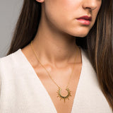 Photo detail of woman with Elysse Gold necklace. Adamina