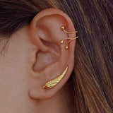 Ear with Soft Gold earring and another gold earring from Adamina collection
